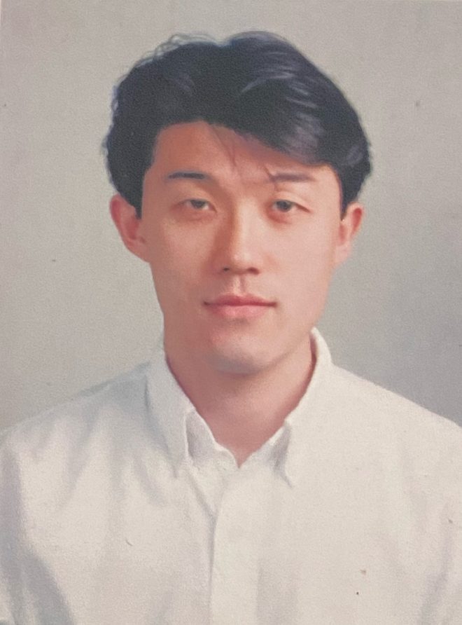 ID photo of a young man in a white shirt